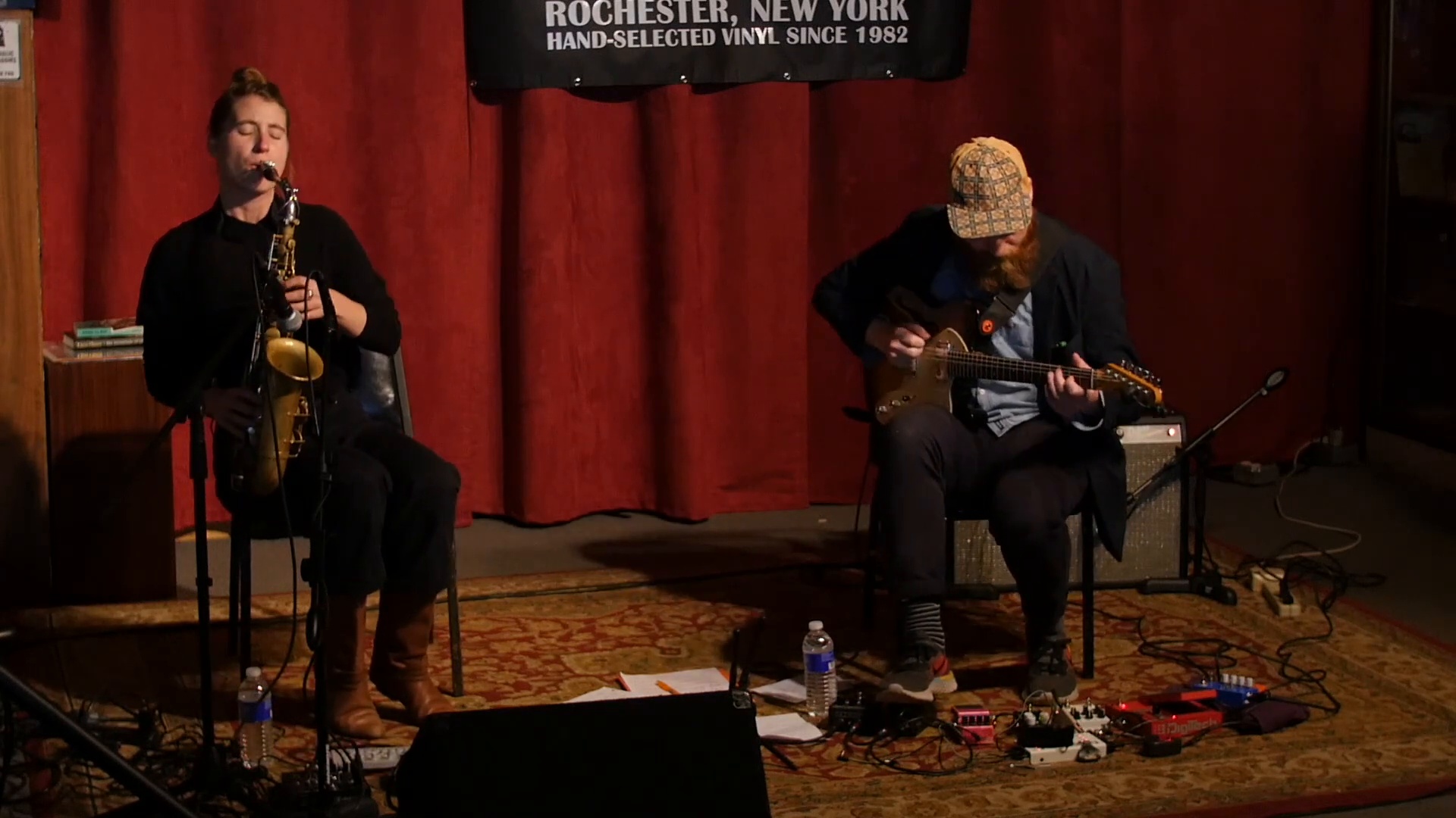 Stage performance with saxophone and electric guitar